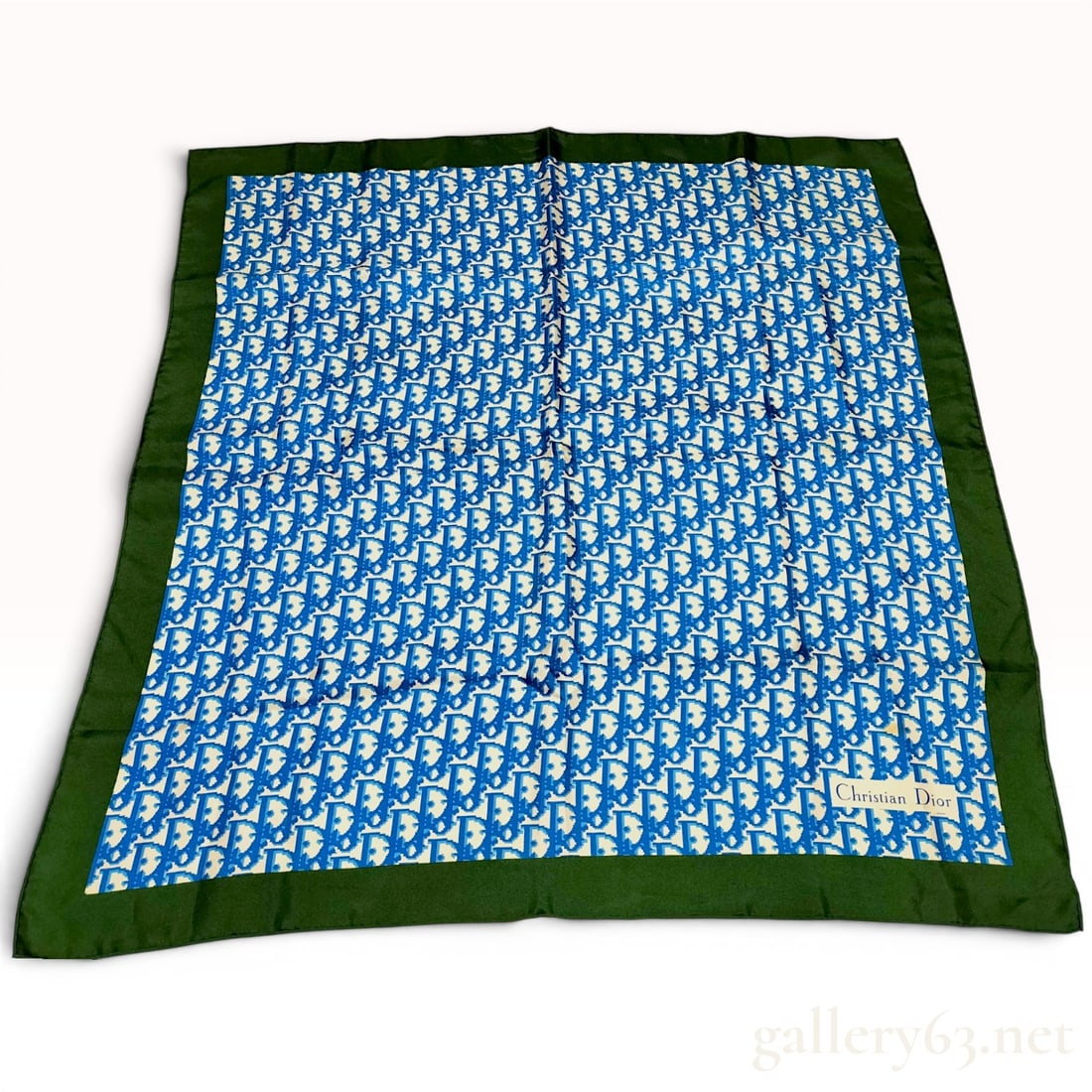 Christian Dior Vintage Oblique Monogram Silk Scarf: Christian Dior vintage silk scarf featuring the classic Oblique monogram pattern, circa 1990s. The design consists of a blue and white logo field framed by a wide, solid forest green border. Construct