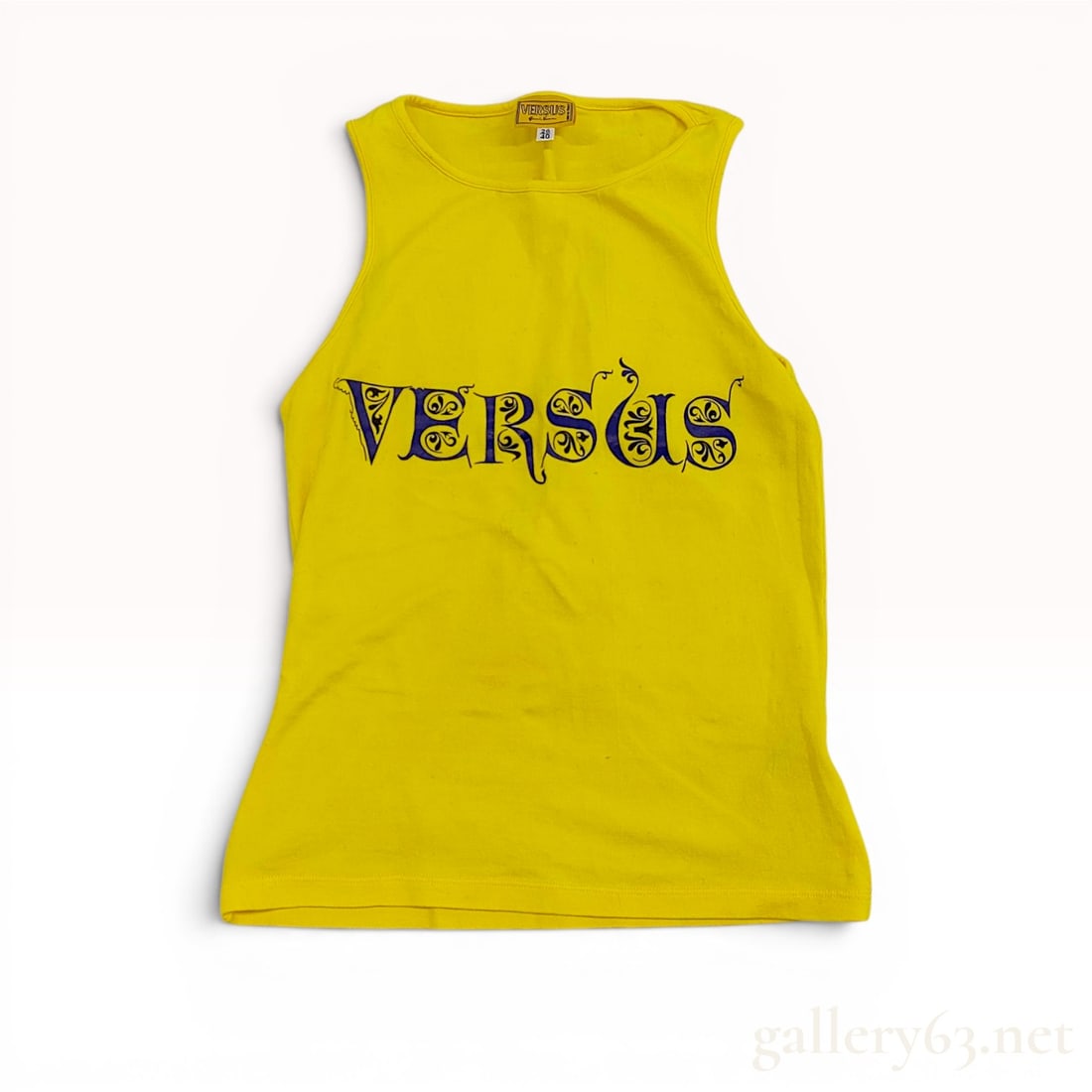 1990s Versus by Gianni Versace Yellow Graphic Logo Tank Top: Versus by Gianni Versace sleeveless tank top, circa 1990s. Constructed from a bright yellow stretch cotton blend, the front features a large navy blue screen-printed ornate logo with decorative scroll