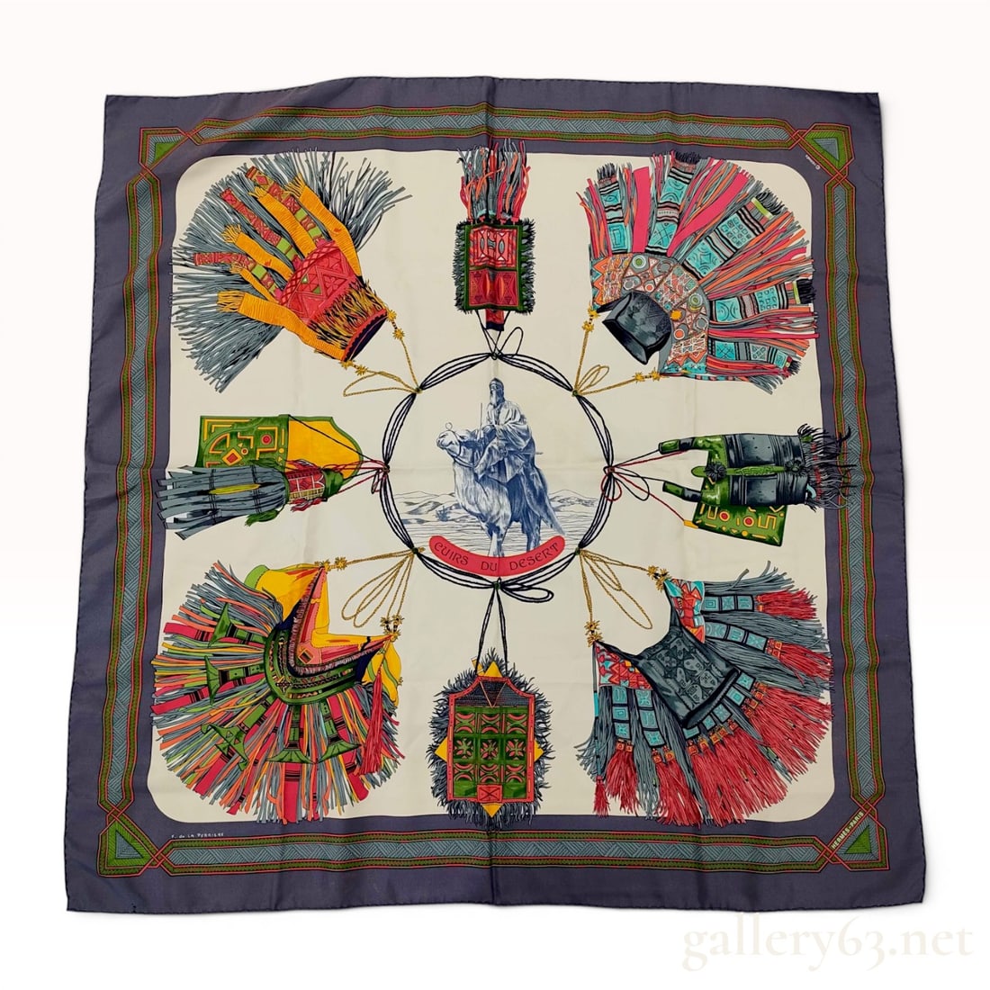 Hermes Silk Carre Scarf Cuirs du Desert by Francoise de la Perriere: Hermès 100% silk scarf in the Cuirs du Désert pattern designed by artist Françoise de la Perrière. The screen-printed design features a central Tuareg camel rider surrounde