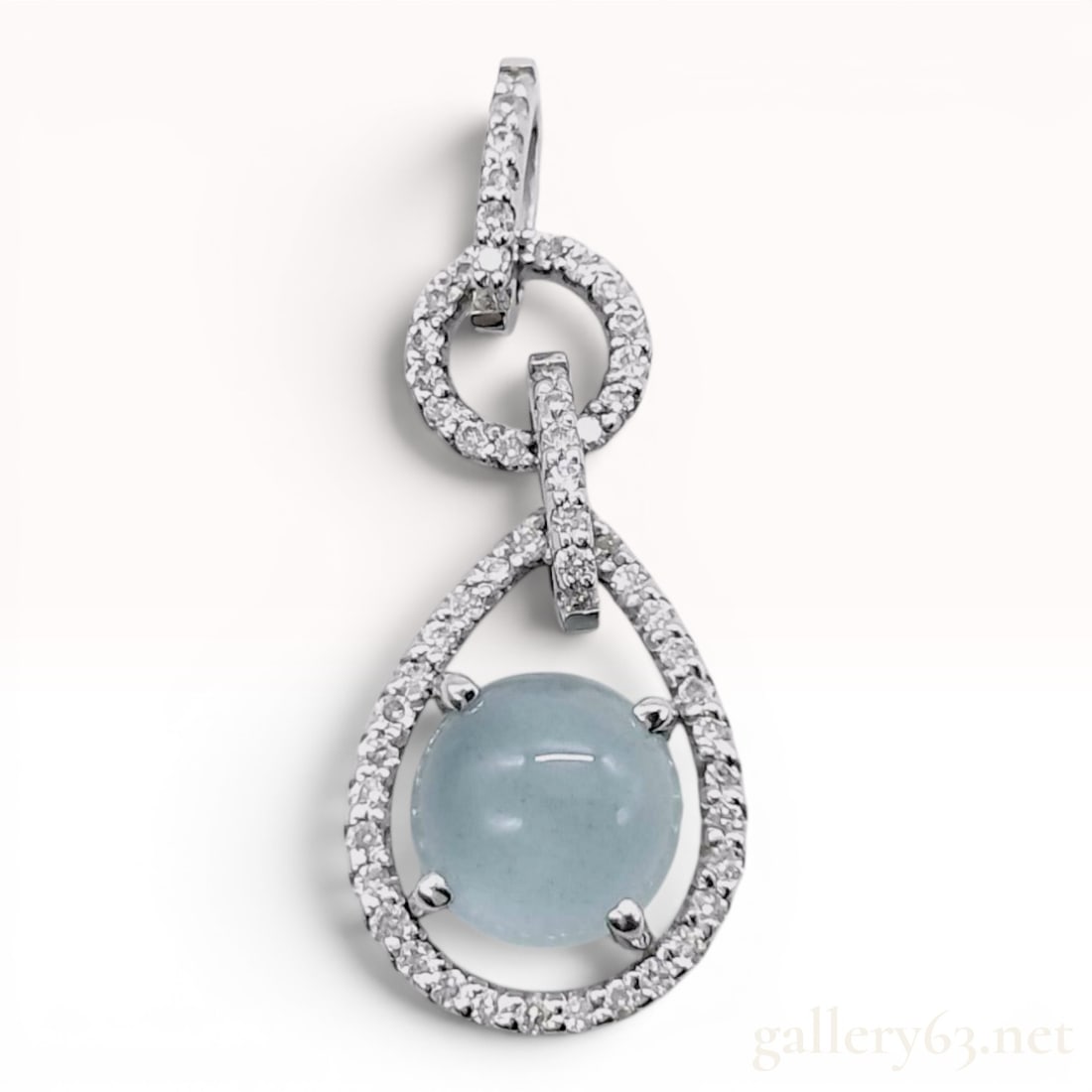 18K White Gold Aquamarine Cabochon and Diamond Articulated Drop Pendant: An 18-karat white gold articulated drop pendant featuring a central light blue cabochon-cut aquamarine and round brilliant-cut diamond accents. The pendant is constructed of three interconnected, arti