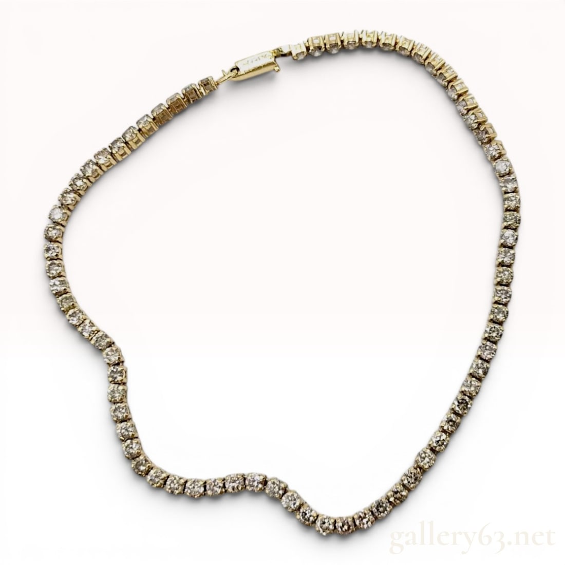 18K Yellow Gold and 3.00 Carat Diamond Tennis Bracelet: This tennis style bracelet is crafted in 18-karat yellow gold and features a continuous line of round brilliant-cut diamonds. Each diamond is individually secured in a four-prong basket mounting withi