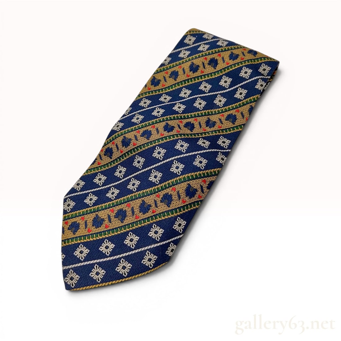 Christian Dior Monsieur Vintage Silk Geometric Pattern Necktie: A vintage men's necktie from the Christian Dior Monsieur line. The tie is constructed from 100% silk and was hand made in France. The design features a complex diagonal striped pattern consisting of n