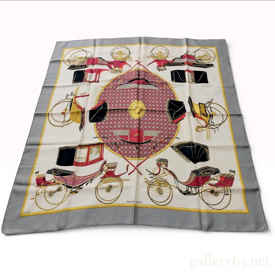 Hermes Les Voitures a Transformation Silk Scarf by Francoise de la Perriere: An Hermes silk twill scarf featuring the Les Voitures a Transformation pattern designed by artist Francoise de la Perriere. The design depicts various components of horse-drawn carriages, such as whee
