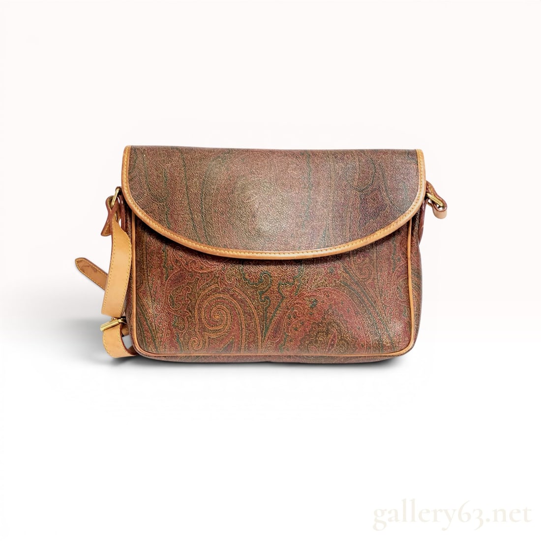 Vintage Etro Paisley Coated Canvas Crossbody Bag: This vintage crossbody bag by Etro is crafted from the brand's signature paisley-printed coated canvas in a palette of brown, tan, green, and red. The bag features a curved front flap that closes with