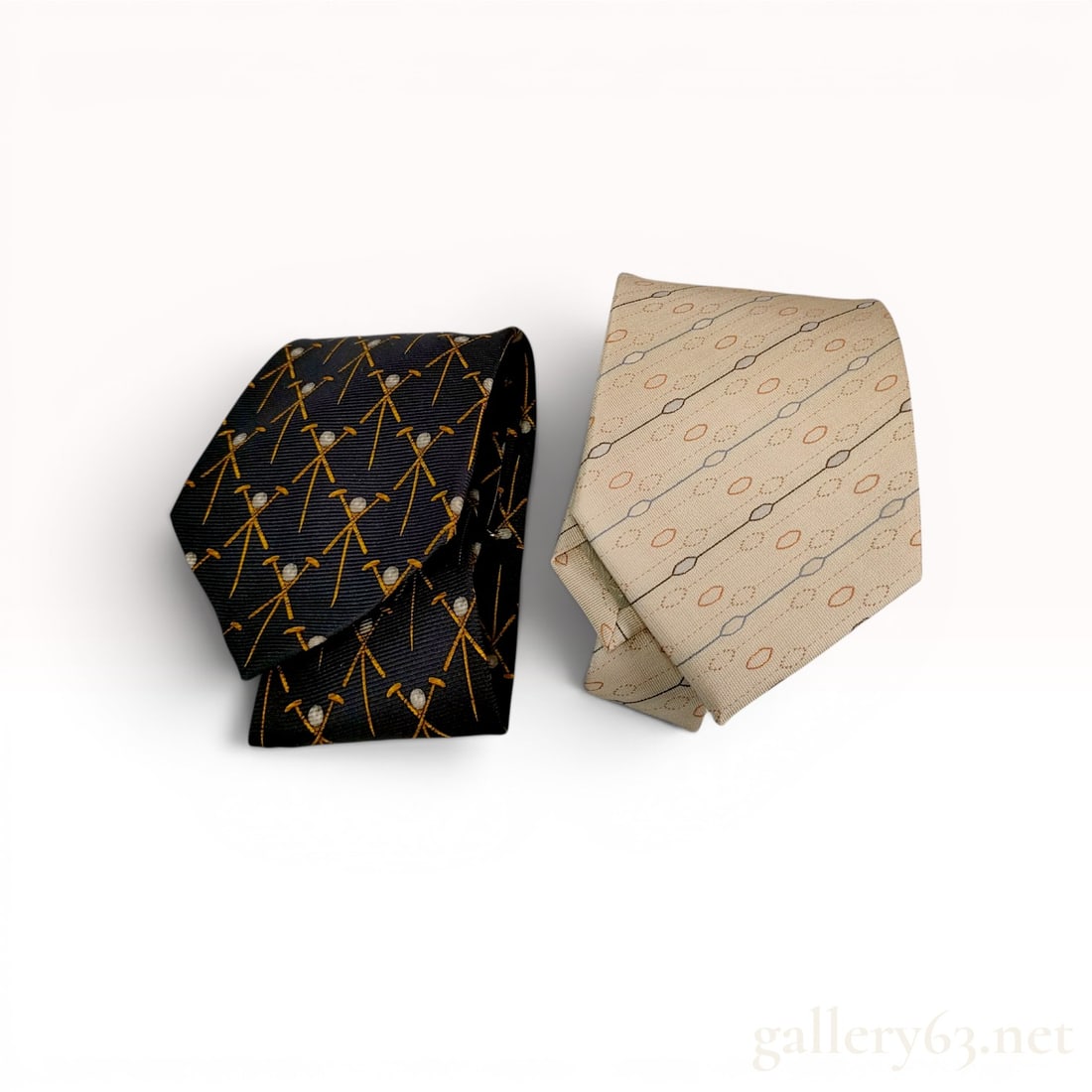Two Designer Silk Neckties, Chanel and Chloe Homme: This lot consists of two designer silk neckties from Chanel and Chloe. The first tie is a Chanel 100 percent silk necktie made in Italy. It features a dark navy or black ground decorated with a repeat