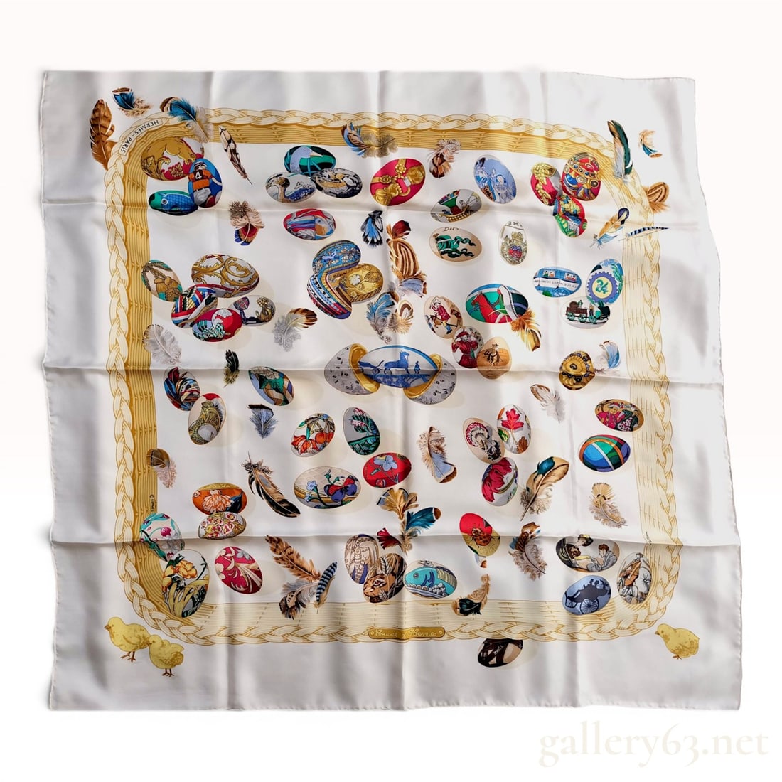 Hermes Couvee d'Hermes Silk Scarf by Caty Latham: This Hermes silk scarf features the Couvee d'Hermes (The Hermes Brood) pattern, designed by artist Caty Latham. The central design depicts a white field scattered with various ornamental eggs and mult