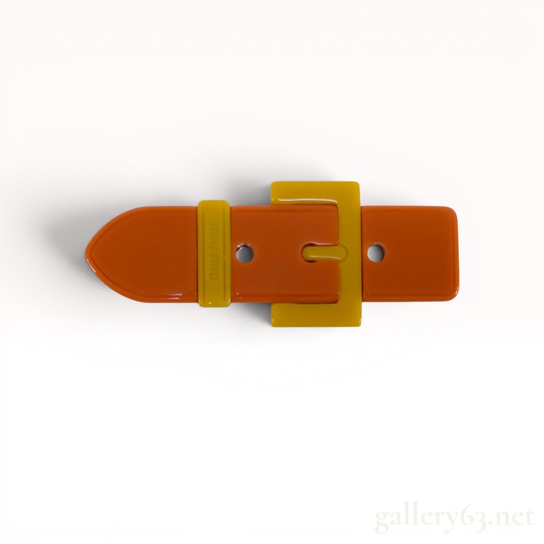 Miu Miu Two-Tone Resin Belt Buckle Brooch with Box: This designer brooch by Miu Miu is crafted in the form of a miniature belt buckle. The piece features a high-gloss orange resin strap with a contrasting yellow resin buckle and keeper. The keeper is d