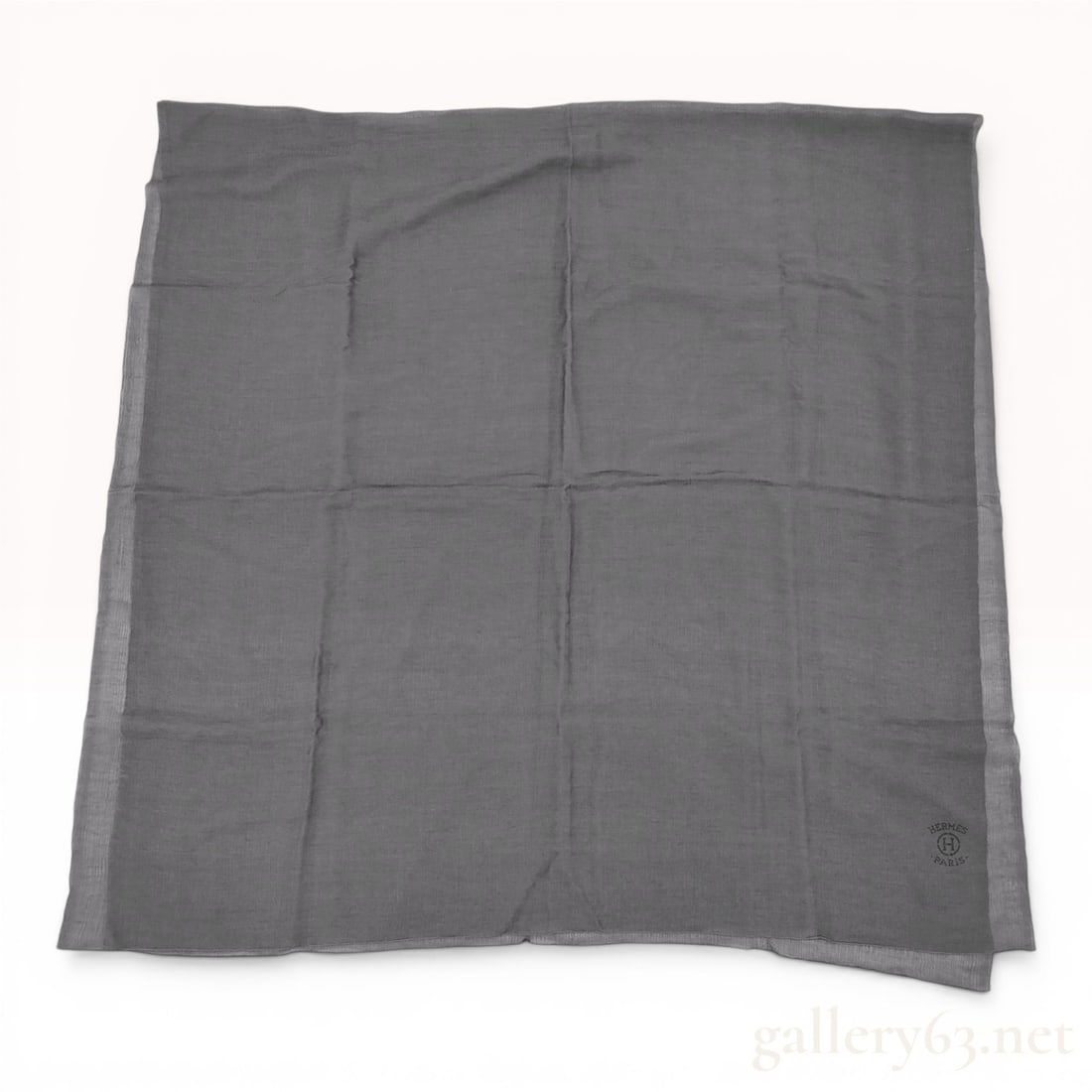 Hermes Charcoal Gray Cashmere and Silk Square Shawl: A large square shawl from Hermes, Paris, crafted from a blend of 75 percent cashmere and 25 percent silk. The body of the shawl is a solid charcoal gray, finished with a sheer, lighter gray border on 