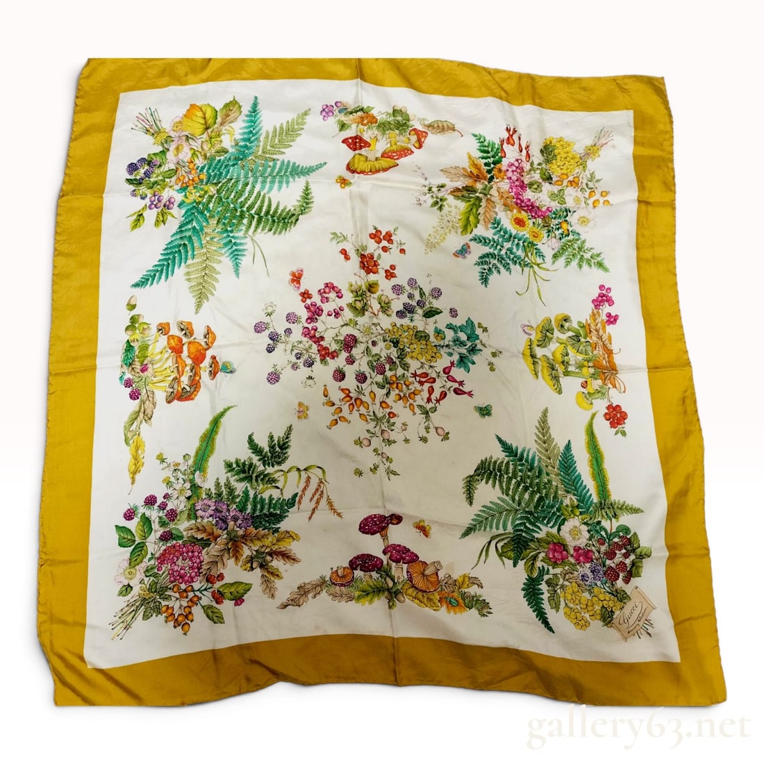 Gucci Accessory Collection Flora Motif Silk Scarf with Mustard Yellow Border: This vintage silk scarf from the Gucci Accessory Collection features the iconic botanical Flora motif. The design includes detailed illustrations of ferns, mushrooms, berries, and various wildflowers 