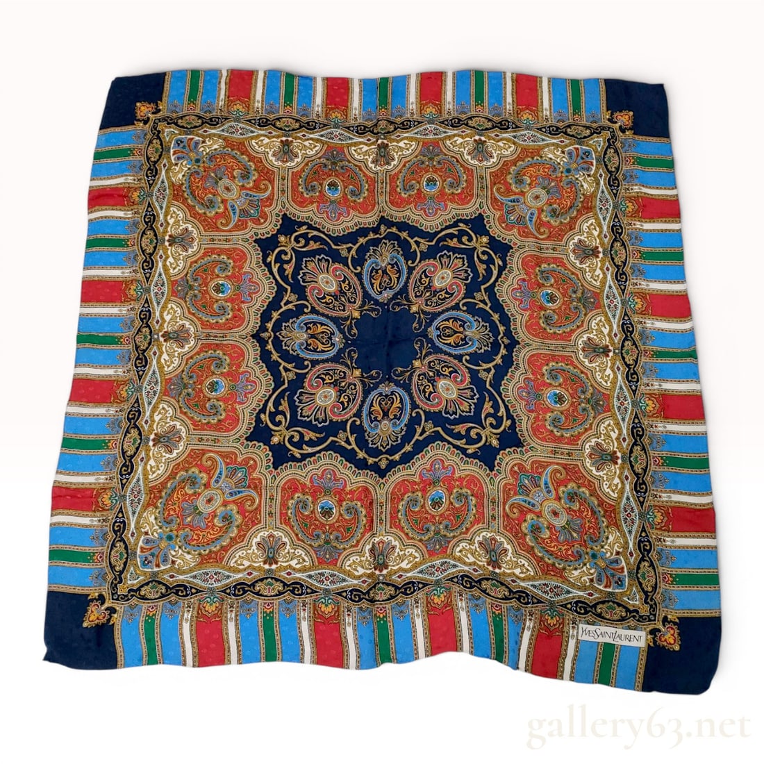 Yves Saint Laurent Vintage Silk Foulard Scarf with Paisley and Medallion Motif: This is a square foulard scarf from the French fashion house Yves Saint Laurent. The scarf is crafted from 100 percent silk and features a tonal polka dot jacquard weave that provides a textured groun
