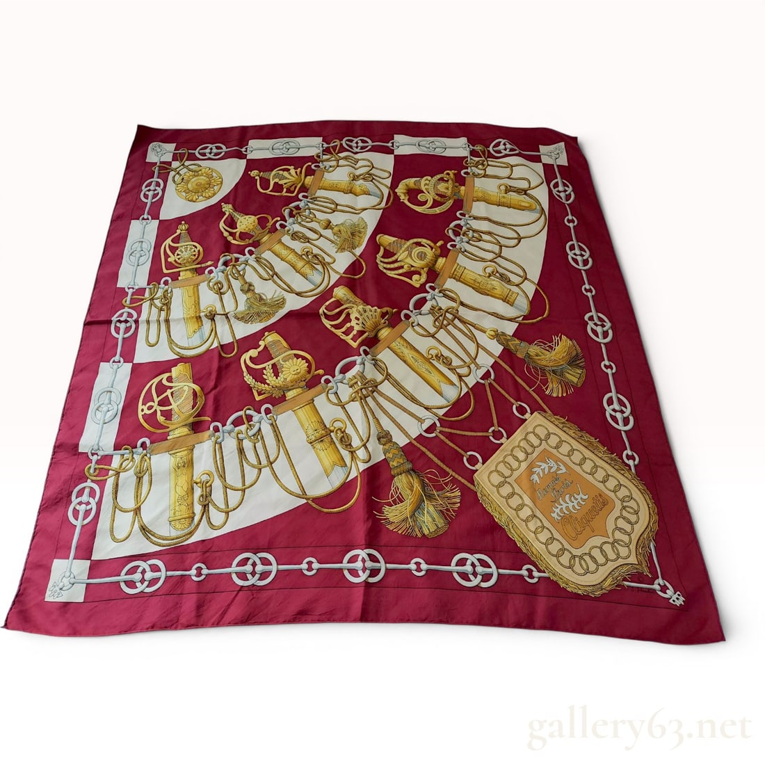 Hermes Cliquetis Silk Scarf by Julia Abadie: A vintage Hermes Paris silk twill scarf in the Cliquetis pattern, originally designed by artist Julia Abadie in 1972. The motif features an array of ornate military sabers and swords with decorative t