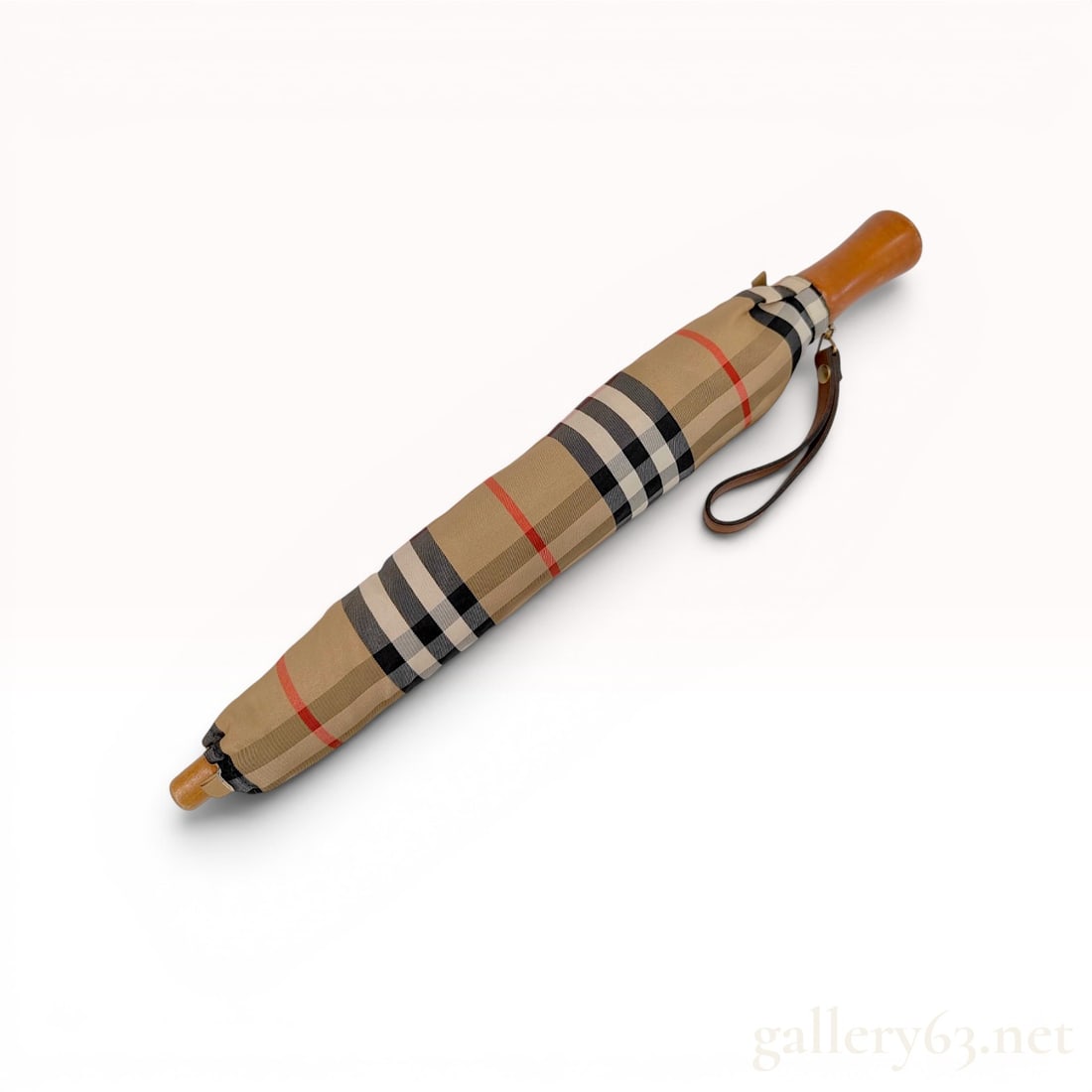 Vintage Burberrys Folding Umbrella in Classic House Check with Matching Sleeve: This vintage folding umbrella features the signature Burberrys house check pattern in tan, black, white, and red. The branding is verified by a metal plate at the base of the handle bearing the Burber
