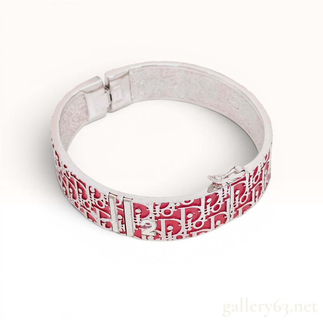 Christian Dior Red Trotter Monogram Hinged Bangle Bracelet: A vintage Christian Dior hinged bangle bracelet featuring the signature Trotter monogram pattern. The silver-toned metal band is decorated with red enamel or resin inlay that forms the repeating logo 