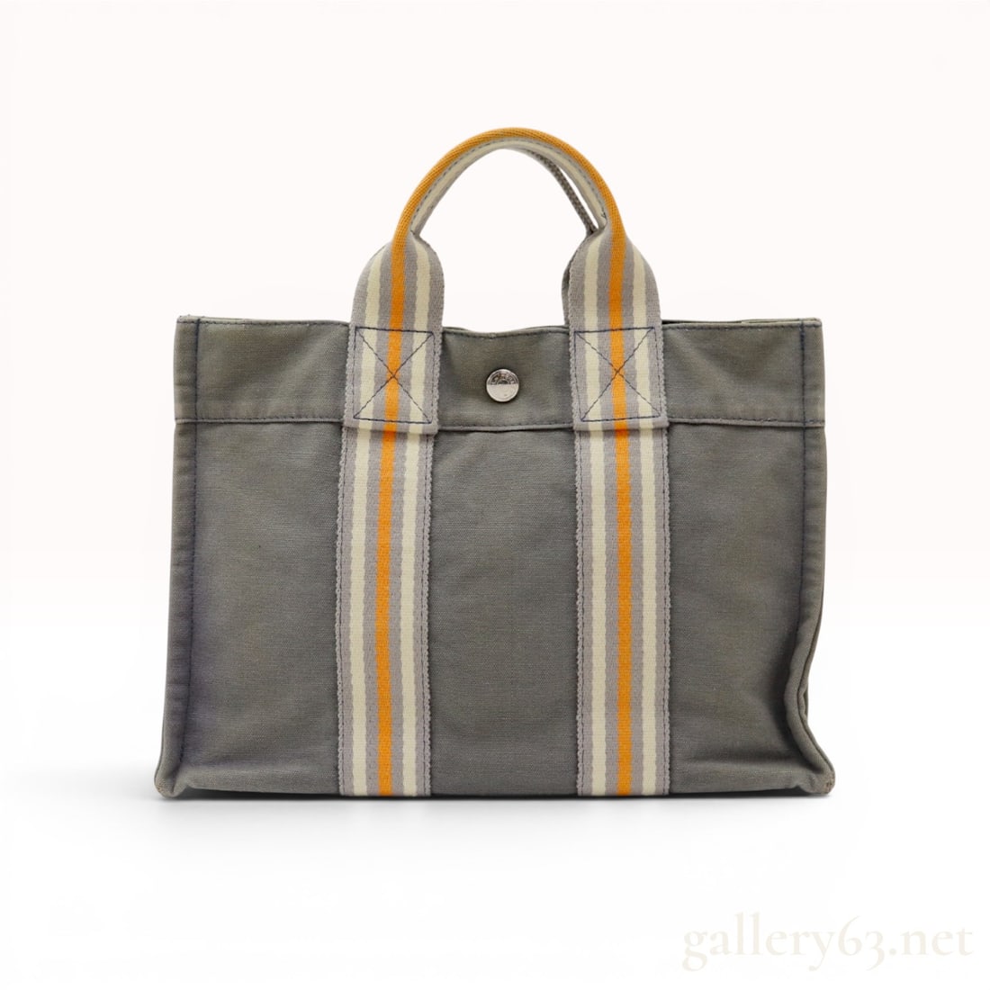 Hermes Herline PM Ginza 2001 Limited Edition Canvas Tote: Hermes Herline PM tote bag, Ginza 2001 Limited Edition. This rectangular tote is constructed of gray canvas with dual vertical woven webbing handles. The handles feature an orange, off-white, and gray