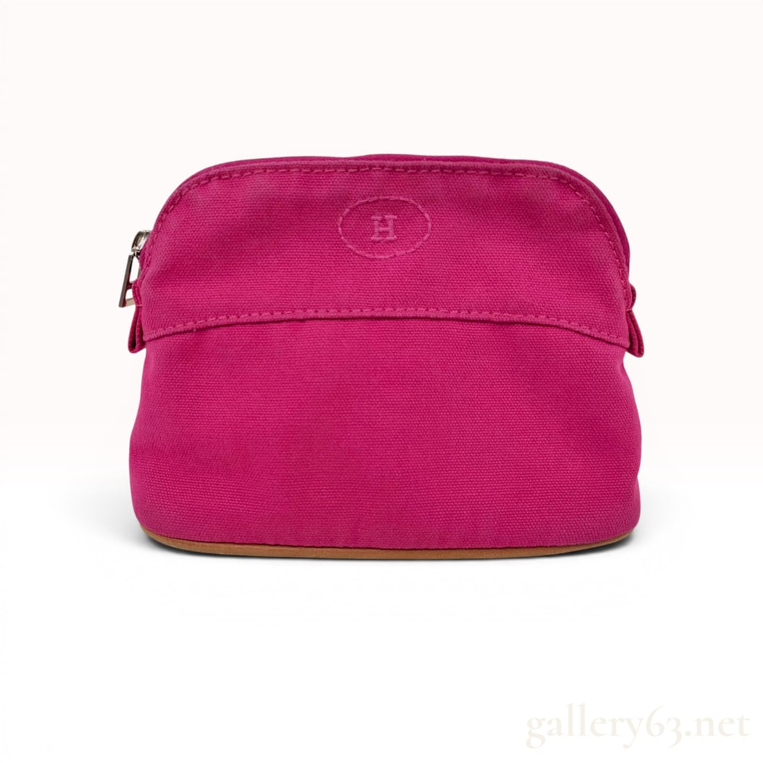 Hermes Bolide Pouch Mini Pink Canvas Pouch: This Hermes Bolide Pouch Mini is crafted from durable fuchsia pink canvas in a classic semi-circular silhouette. The flat base is reinforced with light brown leather piping. The front of the pouch is 
