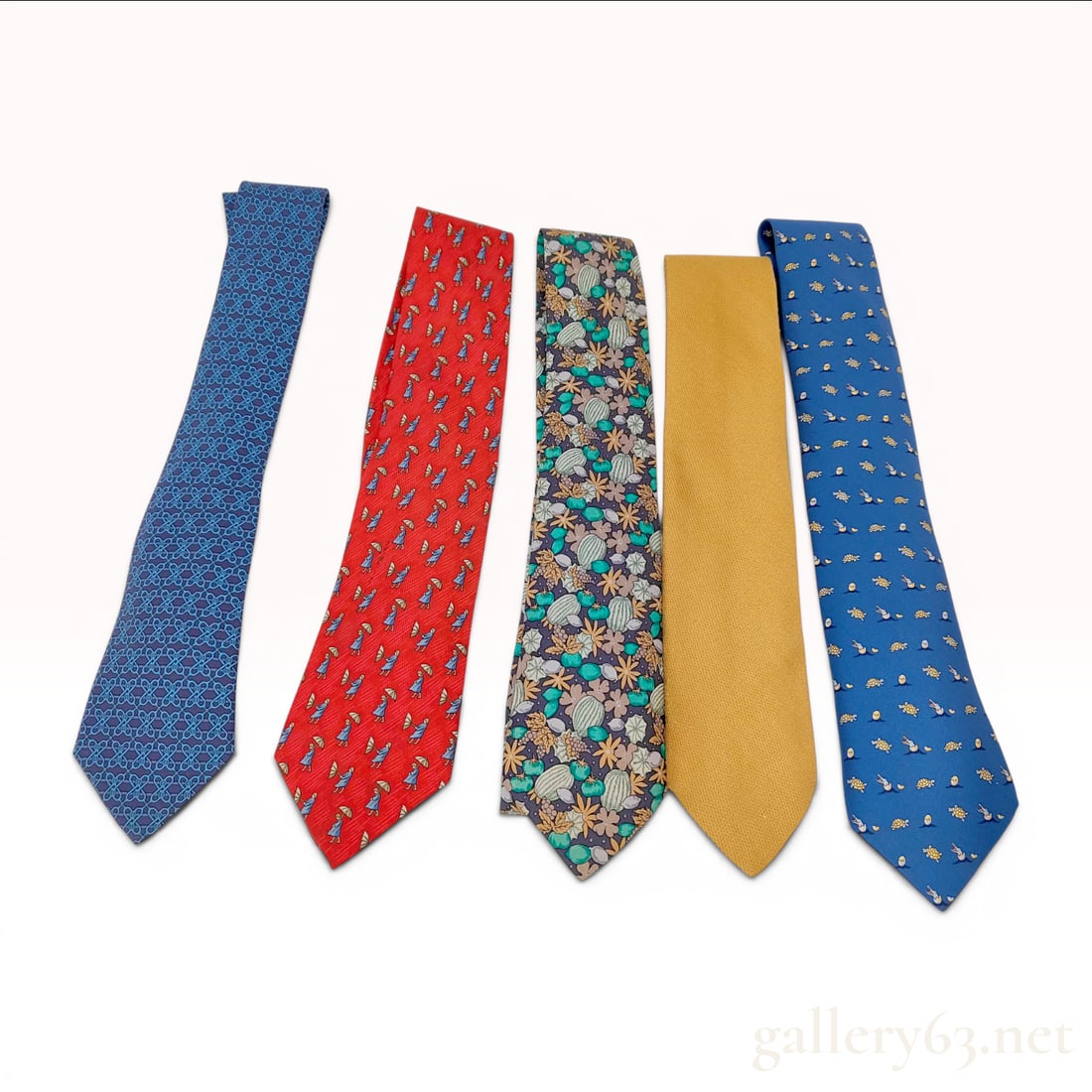 A Lot of Five Hermes Silk Neckties: This lot consists of five silk neckties by the luxury French designer Hermes. All items are constructed from 100 percent silk and feature a range of signature Hermes patterns and textures. The