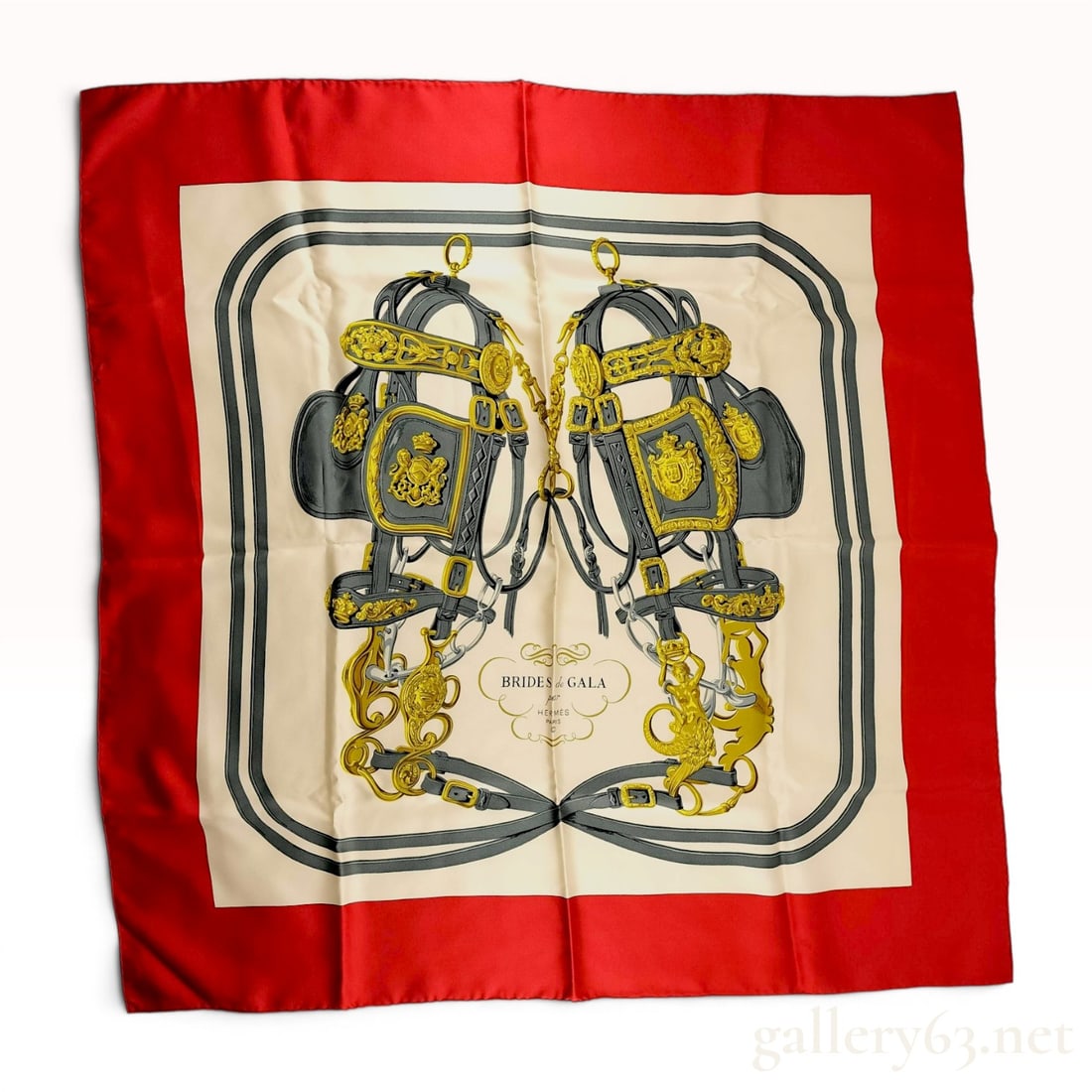 Hermes Brides de Gala Silk Carre 90 Scarf by Hugo Grygkar: An authentic Hermes Paris silk twill scarf featuring the iconic Brides de Gala motif designed by Hugo Grygkar. The design illustrates two ornate horse bridles with intricate gold-toned hardware and cr