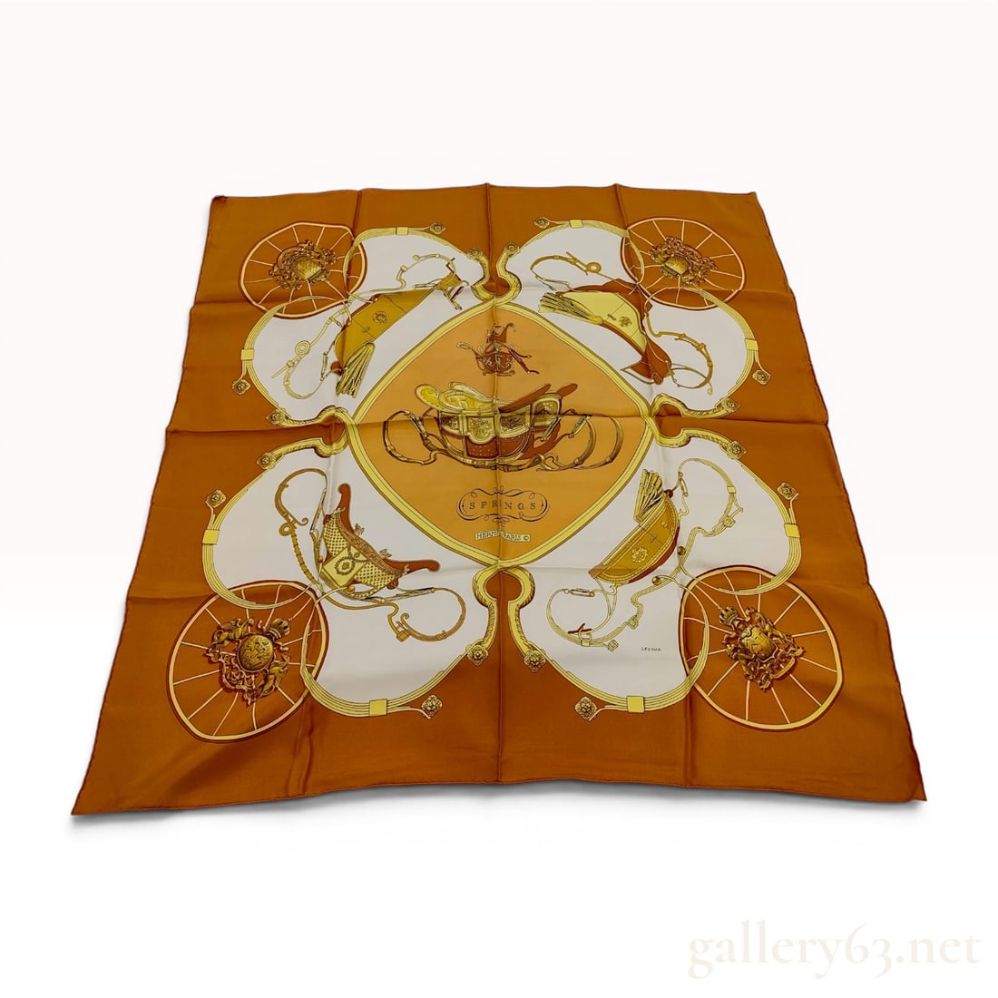 Hermes Springs Silk Carre 90 Scarf by Philippe Ledoux: A vintage Hermes silk twill scarf in the Springs pattern, designed by artist Philippe Ledoux and first issued in 1974. The central motif features a horse-drawn carriage within a tan diamond-shaped fie