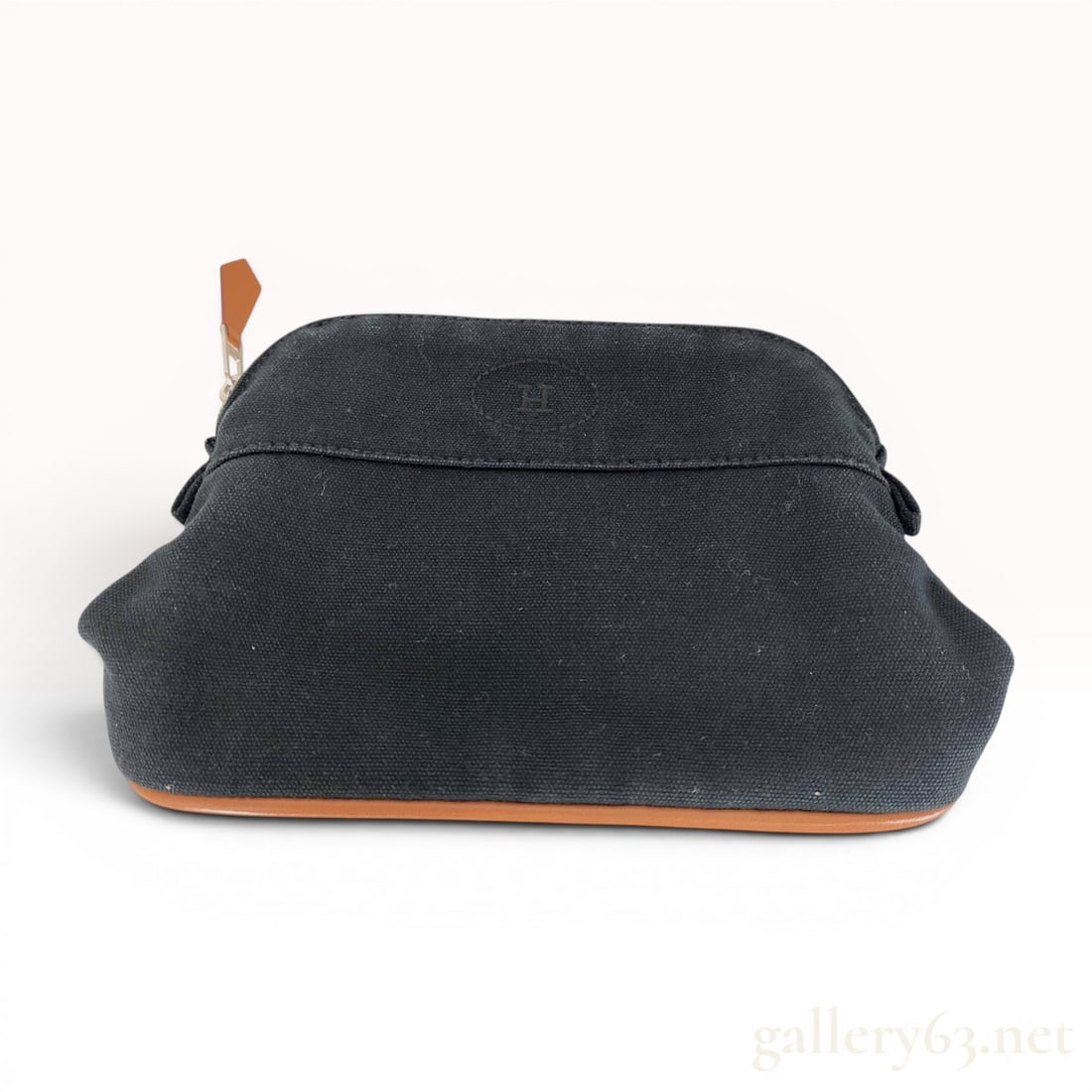 Hermes Black Cotton Canvas Bolide Travel Cosmetic Pouch MM: This is an Hermes Bolide travel case or cosmetic pouch in the MM size. The body is crafted from black cotton canvas with a structured silhouette, accented by tan leather piping around the oval base. T