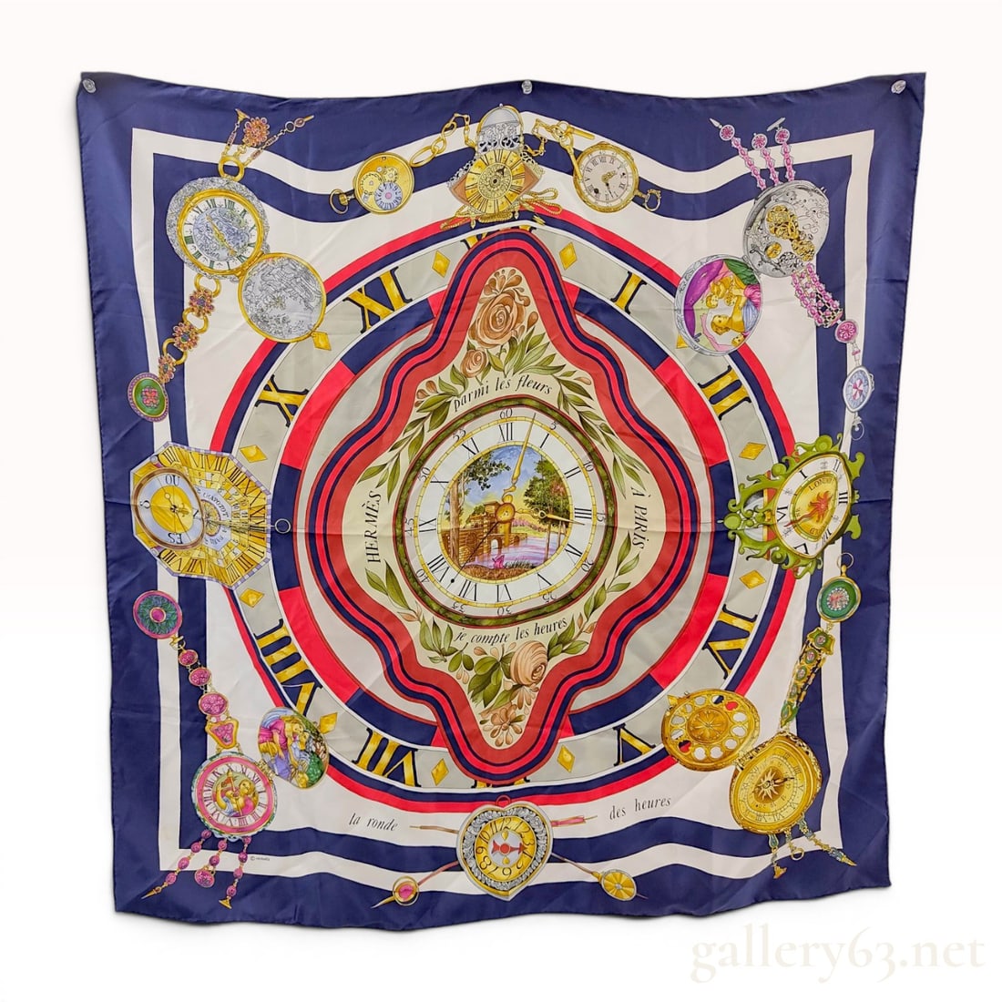 Hermes La Ronde des Heures Silk Scarf: Hermes silk carre in the La Ronde des Heures pattern, designed by Loic Dubigeon. The square scarf is constructed of 100 percent silk and features a central clock motif surrounded by various historical