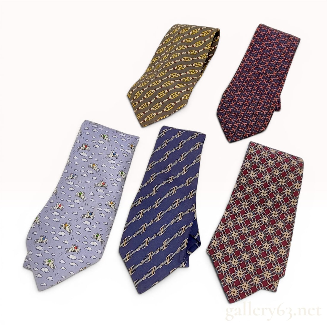 Lot of five (5) Hermes Silk Men's Neckties: A lot of five (5) men's neckties manufactured by Hermes, Paris. All ties in the collection are constructed of 100 percent silk. The grouping includes five distinct patterns: one light blue ground feat