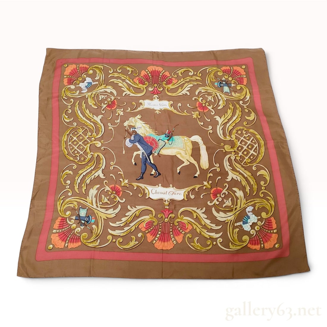 Hermes Cheval Turc Silk Carre 90: A square silk twill scarf from Hermes featuring the Cheval Turc or Turkish Horse pattern designed by Christiane Vauzelles. The design depicts a central figure of a groom in traditional attire leading 