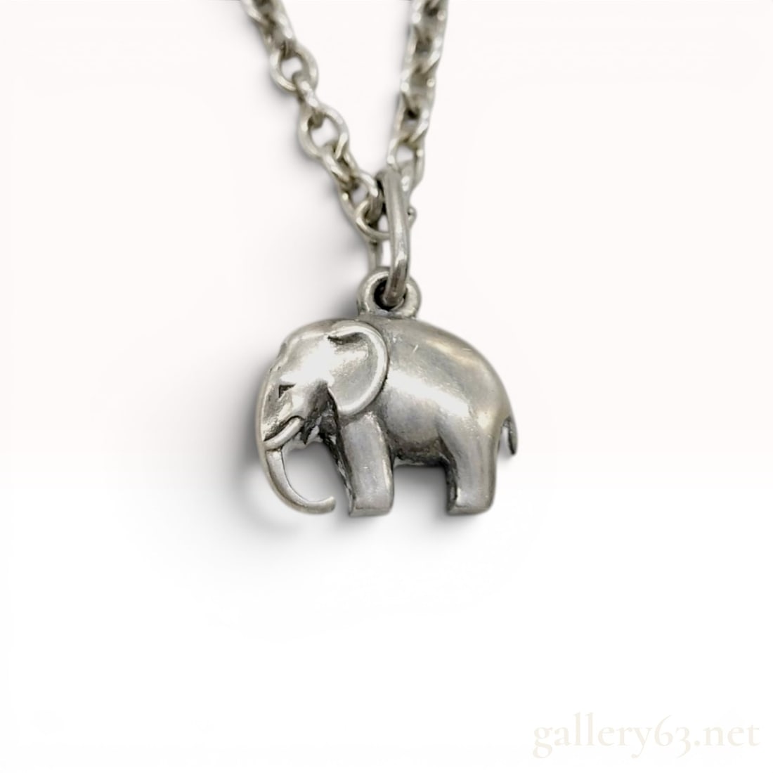 Georg Jensen Sterling Silver Elephant Pendant Necklace: A Georg Jensen sterling silver necklace featuring a three-dimensional elephant pendant. The pendant depicts a stylized elephant with its trunk lowered and is suspended from a sterling silver cable-lin