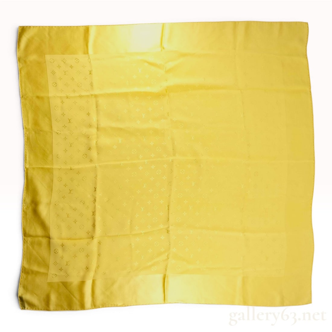 Louis Vuitton Yellow Monogram Jacquard Silk Scarf: A square silk scarf by Louis Vuitton in a vibrant yellow tone. The piece is constructed from a 100% pure silk fabric featuring a tone-on-tone jacquard weave that displays the signature Louis Vuitton m