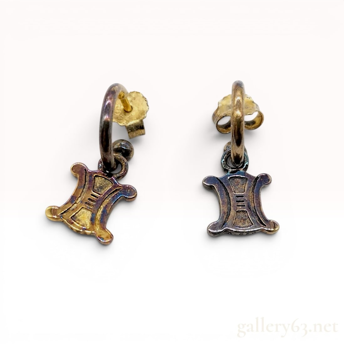 A Pair of Celine Sterling Silver Hoop Earrings with Triomphe Motif Charms, Gold Plated: This is a matched pair of designer earrings by Celine featuring the signature Triomphe motif. Each earring is designed as a small C-hoop post with a ball finial, supporting a dangling flat charm in th