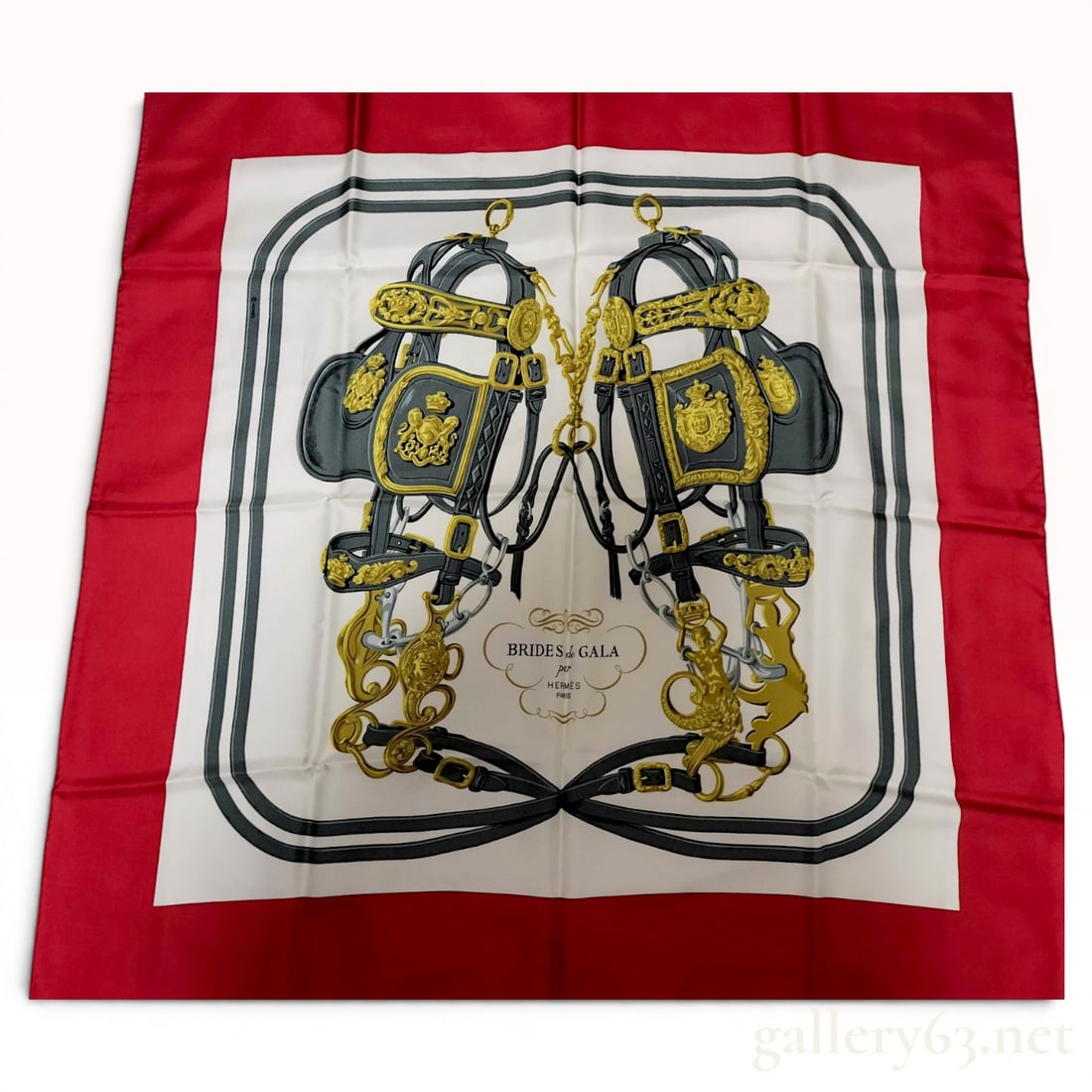 Hermes Paris Brides de Gala Silk Scarf: Hermes Paris silk twill scarf in the Brides de Gala pattern, originally designed by Hugo Grygkar in 1957. The design features two ornate equestrian bridles with gold-toned hardware and heraldic crests
