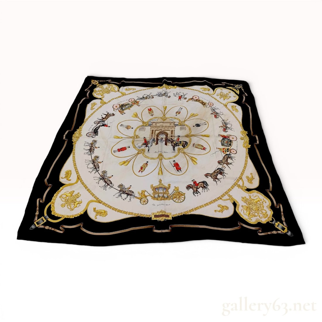 Hermes The Royal Mews Silk Scarf 90: Vintage silk twill scarf from Hermes titled The Royal Mews. The design features a central circular motif depicting the gated entrance to Buckingham Palace, surrounded by various British state carriage