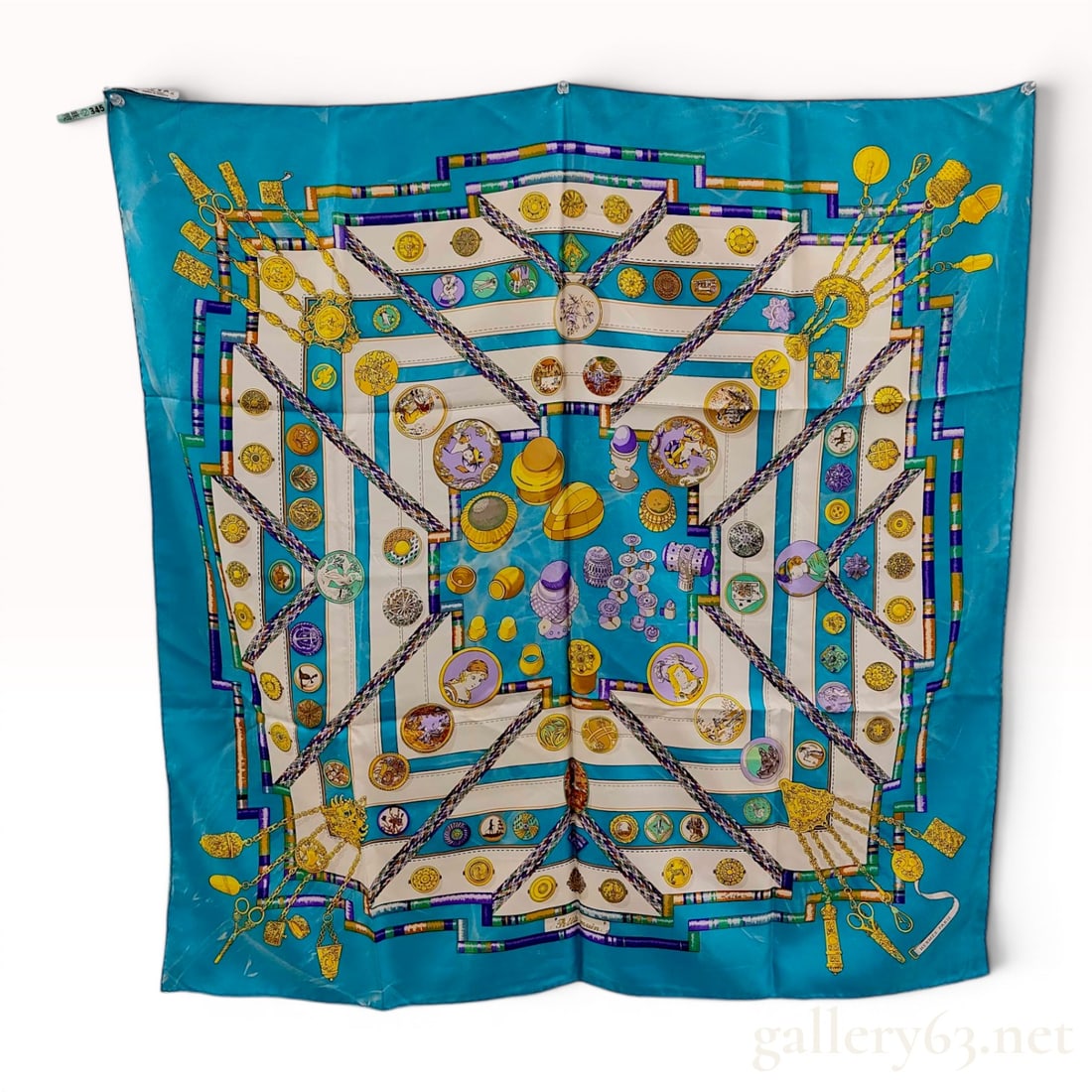 Hermes Petite Main Silk Scarf Signed Pellegrin in Turquoise: This Hermes silk twill scarf features the Petite Main pattern, a classic design attributed to Catherine de Karolyi, who signed the artwork under the pseudonym Pellegrin. The composition showcases a vi