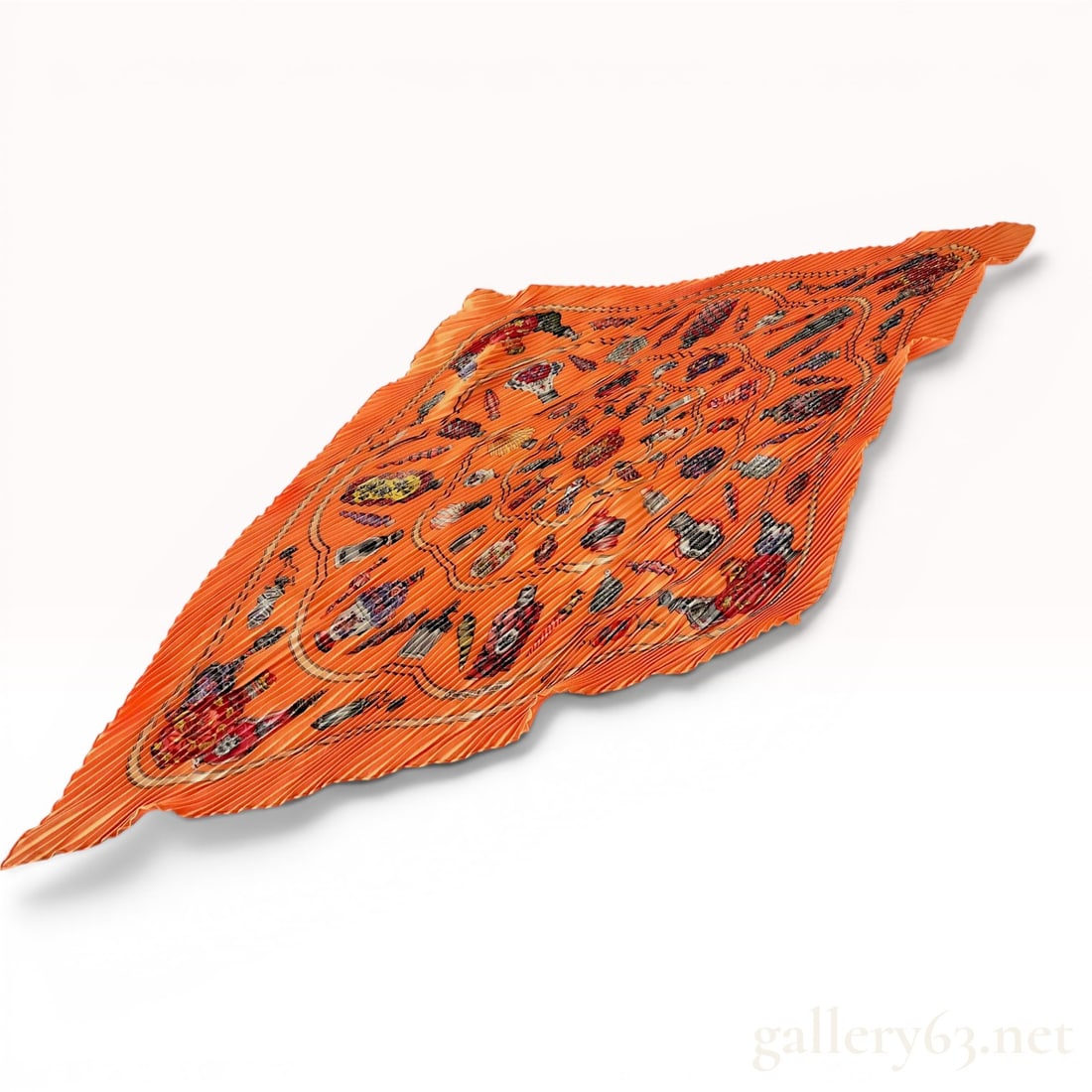 Hermes Qu'importe le flacon Plisse Silk Scarf: Hermes Plisse silk scarf in the Qu'importe le flacon pattern designed by artist Catherine Baschet. The design features a detailed assortment of antique and classic perfume bottles rendered in red, gol