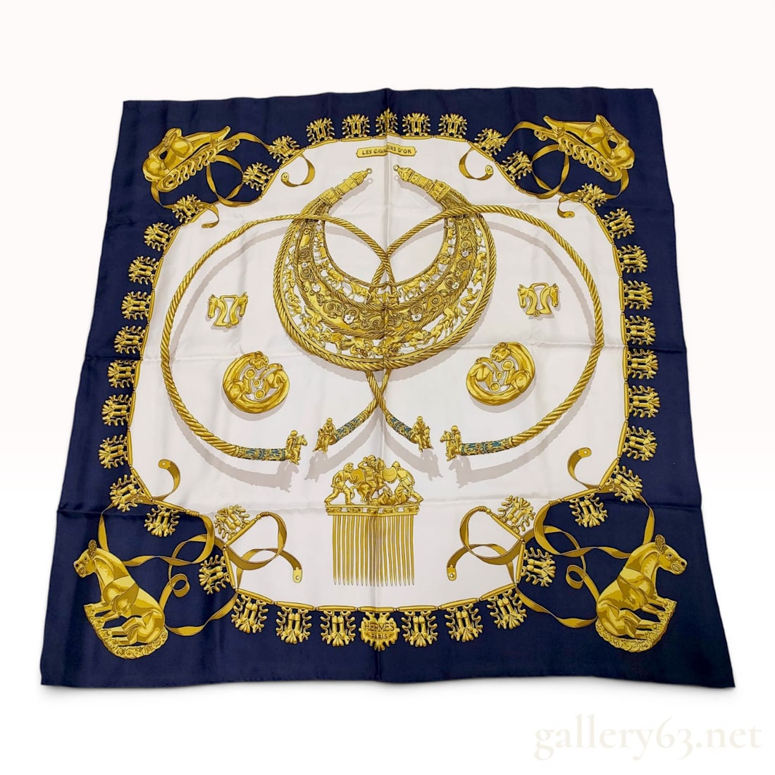 Hermes Les Cavaliers d'Or Silk Carre Scarf: A 100% silk Hermes Paris scarf in the Les Cavaliers d'Or (The Golden Horsemen) pattern, designed by Vladimir Rybaltchenko and first issued in 1975. The design features various ancient Scythian gold ar