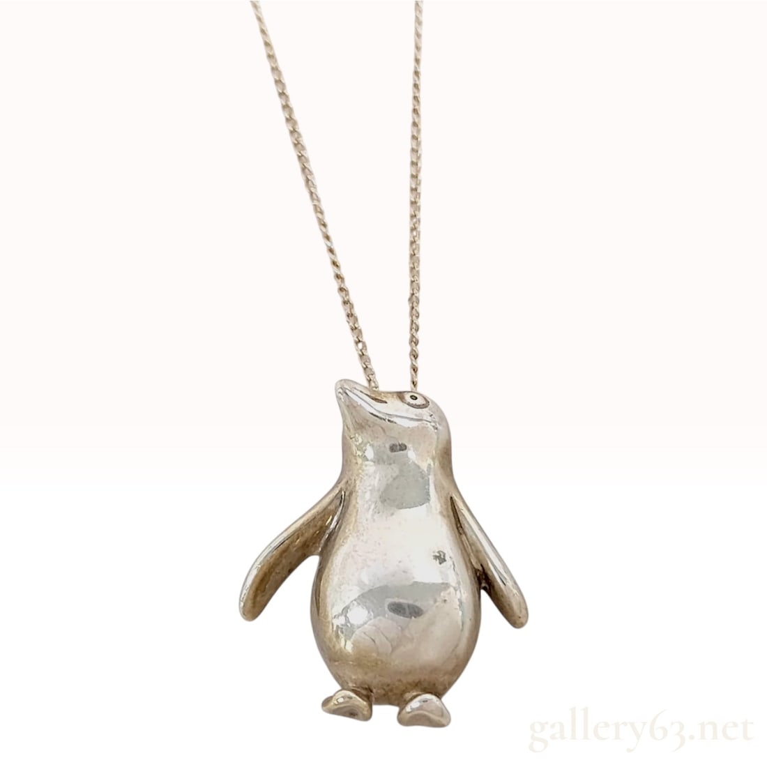 Tiffany & Co. Sterling Silver Penguin Pendant Necklace: A sterling silver pendant necklace from Tiffany & Co. featuring a stylized penguin pendant attributed to Elsa Peretti. The pendant is three-dimensional with a high-polished convex front and a holl