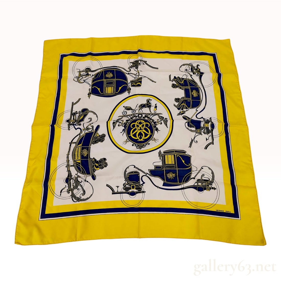 Hermes Ex-Libris Pattern Silk Scarf in Yellow and Navy Blue: Silk scarf from Hermes, Paris, featuring the classic Ex-Libris pattern. Designed by Hugo Grygkar and first introduced in 1946, this design features a central circular emblem depicting a horse-drawn ca