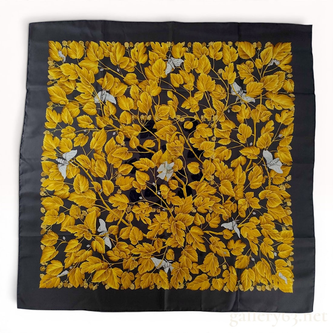 Hermes L'Arbre de Soie Silk Scarf by Annie Faivre: This square silk twill scarf features the L'Arbre de Soie design by artist Annie Faivre for Hermes. The pattern displays an intricate composition of mulberry leaves and branches inhabited by silkworms
