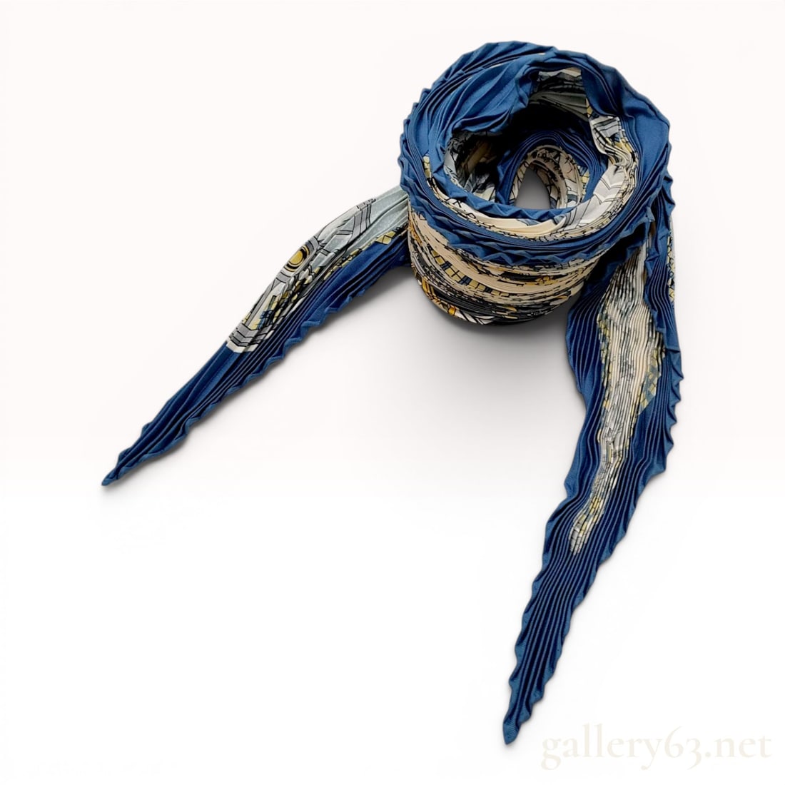 Hermes Plisse Silk Scarf in Les Voitures a Transformation Pattern: A Hermes plisse (pleated) silk scarf featuring the Les Voitures a Transformation pattern, originally designed by Francoise de la Perriere. The design depicts various horse-drawn carriages arranged wit