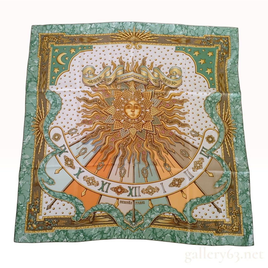 Hermes Carpe Diem Silk Carre Scarf: An Hermes silk twill scarf in the Carpe Diem pattern, designed by Joachim Metz. The central motif features a personified sun with a serene face, surrounded by golden rays and stylized floral elements.