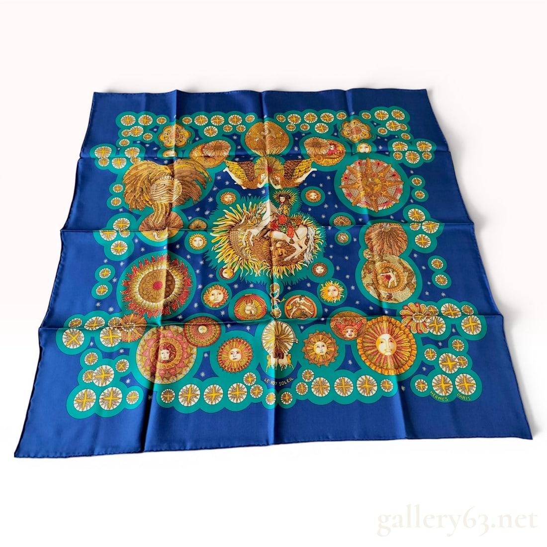 Hermes Le Roy Soleil Silk Carre Scarf by Annie Faivre: A 100 percent silk twill Hermes Carre scarf featuring the Le Roy Soleil (The Sun King) design by artist Annie Faivre, first issued in 1994. The central motif depicts King Louis XIV on a white horse, s