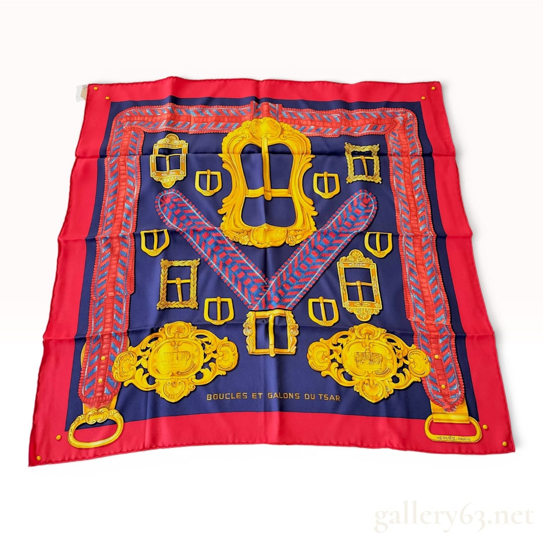 Hermes Boucles et Galons du Tsar Silk Carre 70 Scarf with Box: Hermes silk scarf titled Boucles et Galons du Tsar, designed by artist Wlodek Kaminski. This Carre 70 features a navy blue central field framed by a vibrant red border. The design depicts an array of 