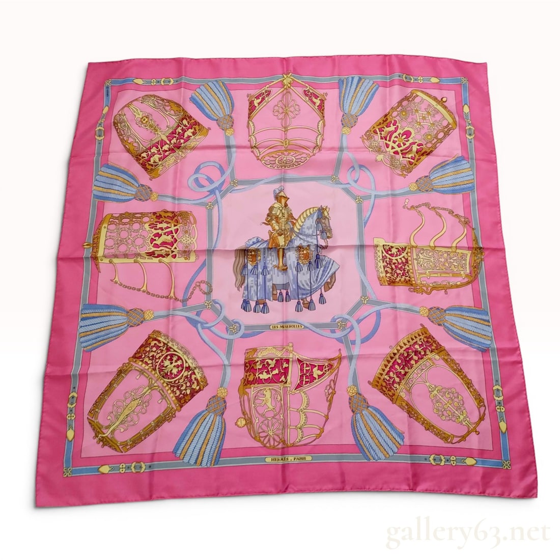Hermes Les Muserolles Silk Scarf by Christiane Vauzelles: This is a Hermes silk twill scarf in the Les Muserolles pattern, designed by artist Christiane Vauzelles. The design features a central medallion of a medieval knight on a caparisoned horse, surrounde