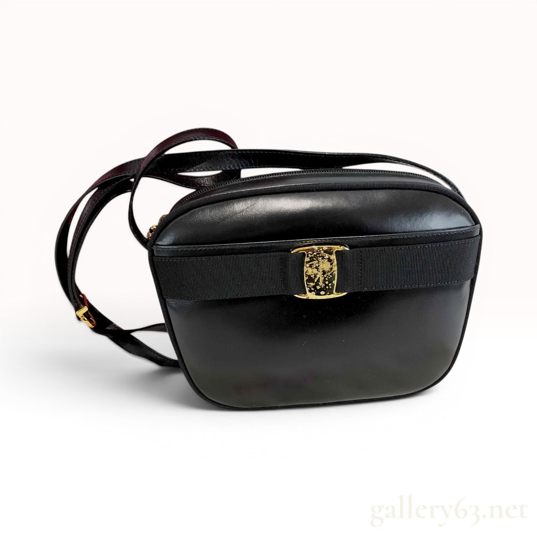 Salvatore Ferragamo Vintage Black Leather Vara Bow Shoulder Bag: A vintage Salvatore Ferragamo shoulder bag, often characterized as a camera bag style, crafted in Italy. The exterior is composed of smooth black calfskin leather and features the signature Vara bow i
