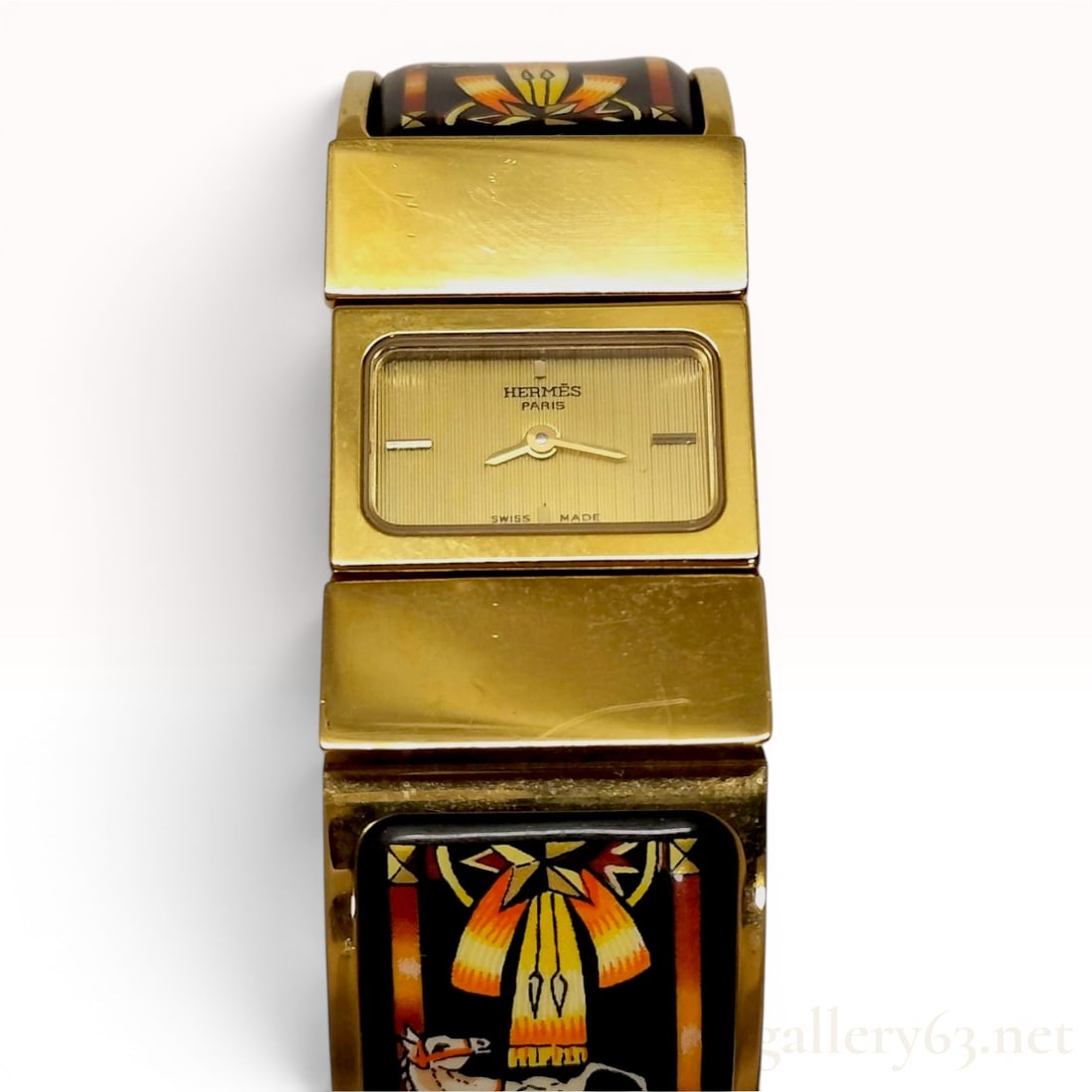 Hermes Loquet Gold-Plated Enamel Bangle Watch LO1.100: An Hermes Loquet bangle watch, reference number LO1.100, featuring a quartz movement. The timepiece is constructed with a gold-plated case and an integrated hinged bangle bracelet. The bracelet is ins