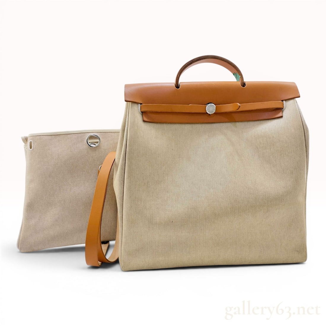 Hermes Natural Toile and Tan Leather Herbag A Dos 2-in-1 Backpack: This Hermes Herbag A Dos (Backpack) 2-in-1 set includes a tan Vache Hunter leather top chassis and two interchangeable natural beige Toile canvas bodies of different heights. The leather chassis is eq