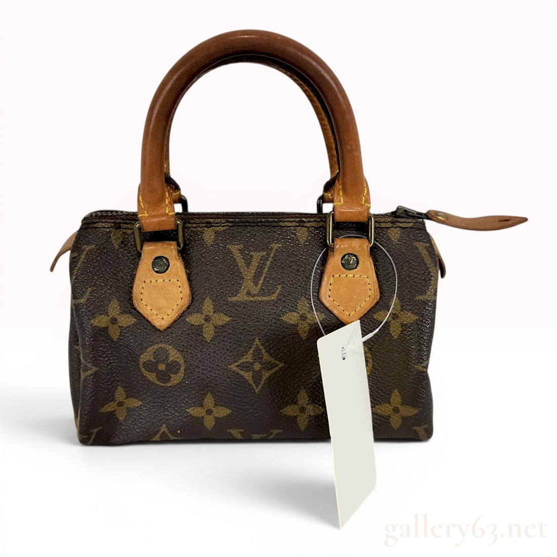 Louis Vuitton Monogram Mini Sac HL Speedy Bag: A vintage Louis Vuitton Mini HL Speedy bag, also known as the Mini Sac HL, produced in the iconic monogram coated canvas. This miniature doctor bag style features natural cowhide leather trim includin