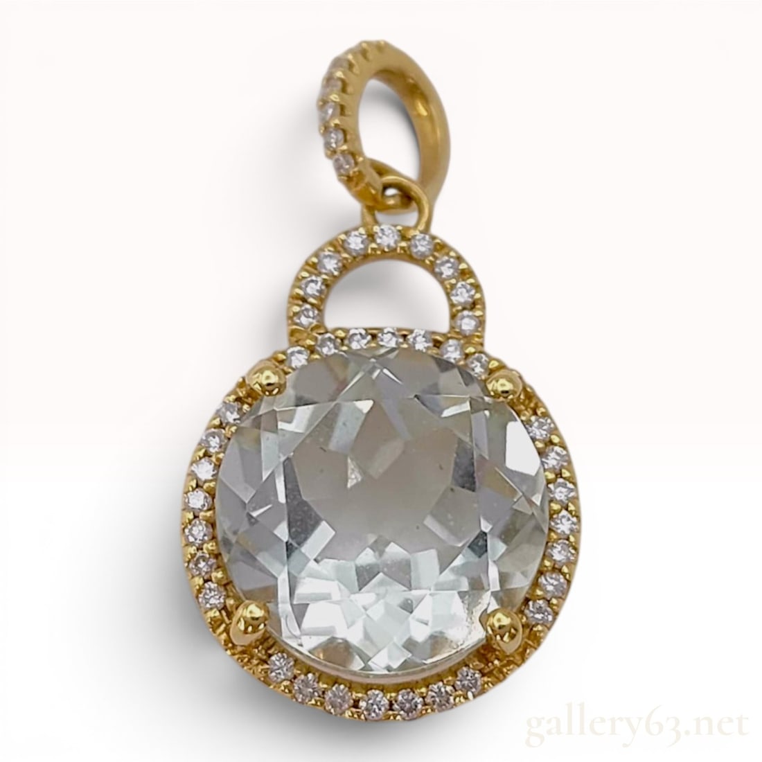 18K Yellow Gold 4.78ct Colored Stone and Diamond Double Tiered Pendant: A double-tiered circular pendant crafted in 18 karat yellow gold. The main lower element houses a large round faceted pale green gemstone, possibly prasiolite, held in a four-prong setting and encircl