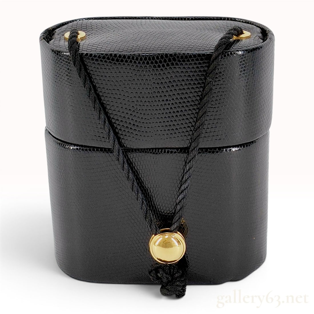Important Vintage Gucci Black Lizard Leather Minaudiere Evening Bag: This vintage evening bag, produced by Gucci, features a hard-sided oval body constructed from black genuine lizard leather. The bag utilizes a black twisted cord drawstring closure that passes through