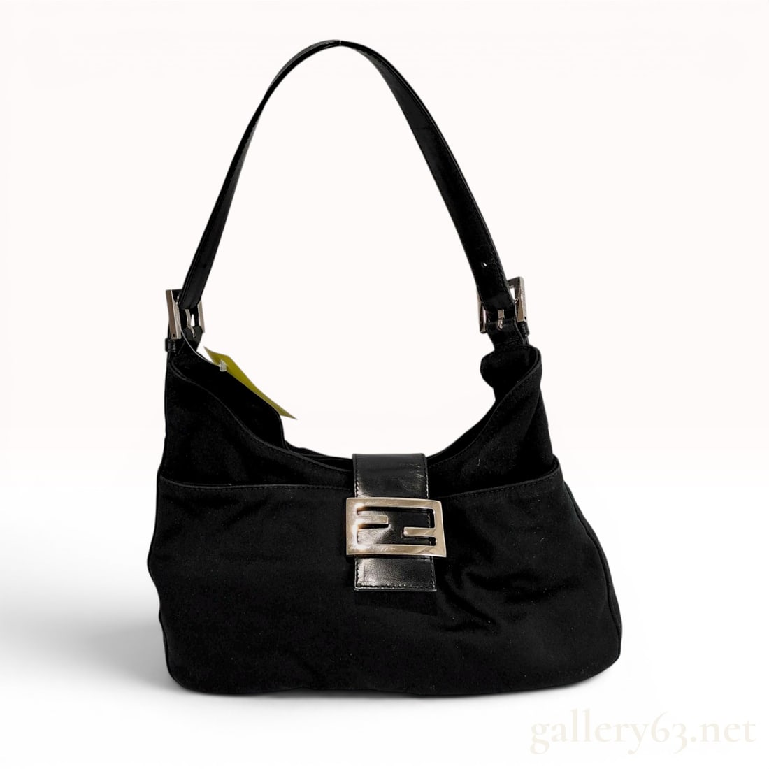 Fendi Black Nylon Mamma Baguette Shoulder Bag: This Fendi Mamma Baguette shoulder bag is crafted with a black nylon fabric exterior and tonal leather accents. It features a classic hobo silhouette with a single flat leather shoulder strap that is 