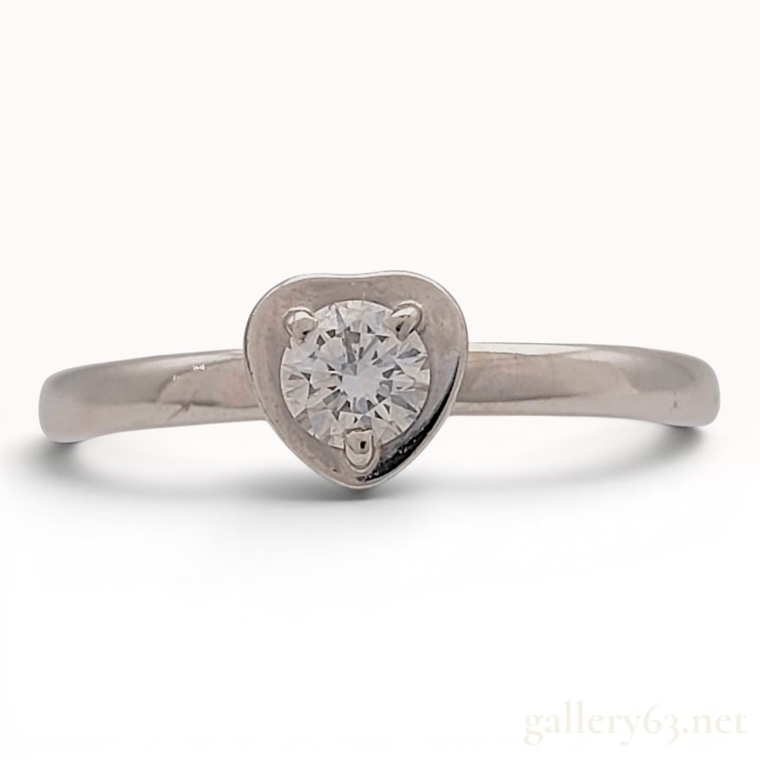 Cartier 18 Karat White Gold and Diamond Diamants Legers Heart Ring with Box: This 18 karat white gold heart-themed solitaire ring is from the Cartier Diamants Legers collection. The design features a single round brilliant-cut diamond secured by three prongs within a polished 